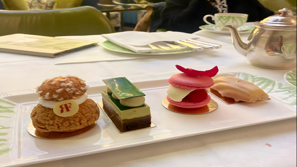 Traditional afternoon tea set with tiered pastry stand and champagne at Palm Court in The Balmoral Hotel Edinburgh.