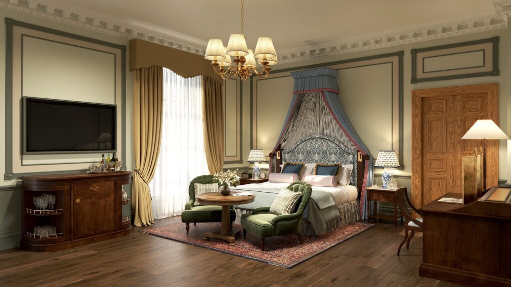 A beautifully styled luxury bedroom at Gleneagles Townhouse Edinburgh, showing elegant period details, plush fabrics, and a large window.